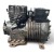 Front-left view of the used Copeland NRB2-040A-TFD 4 HP semi-hermetic compressor (3 phase, 460 volt), showing heavy surface rust and oxidation across the cast housing, exposed valve fittings with gauge ports at top, and cast lettering "LG2" and "001-0063" on the shell.