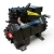 Front-left view of the used Copeland 2DC3-050E-TFC 5 HP Discus compressor (3 phase, 208-230 volt) rotated slightly, showing the red "716" tag, a yellow oil-safety-control checklist tag, and the foil-capped elbow fitting near the nameplate.