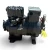 Front-left view of a used Copeland MRB1-050A-TFC 5 HP compressor, 3 phase 208-230 volt, showing the bolted cylinder head, terminal box, and a yellow "ADD OIL TO COMPRESSOR" tag.