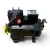 Three-quarter front-left view of a used Copeland 2DA3-R89KE-TFD 7.5 HP compressor, 3 phase 460 volt, with a black housing and a red round inventory tag plus a yellow oil-reminder tag hanging from a brass shutoff valve on top.