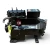 Straight-on front view of two used Copeland 3DS3A-0750-TFC 7.5 HP compressors, 3 phase 208-230 volt, stacked with a gray-black unit in front bearing the blue Copeland Discus nameplate and a second darker unit visible behind it.