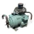 Right-side three-quarter view of the used Carlyle 06DM3376DC3650 10 HP compressor showing a part number stamped into the cylindrical shell, a small terminal box with red and black wire leads at front left, copper tubing on both sides, and a rusted mounting foot.