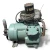 Close three-quarter view of the used Carlyle 06DM3376DC3650 10 HP compressor (3 phase 460 volt), aqua-green housing with a red round inventory tag hanging near the top, a copper refrigerant line bending across the front, and a cluster of valves and fittings at the lower right.