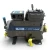 Front view of a used Copeland 3DK3A-120E-TFC 12 HP compressor (3 phase 208-230 volt), gray semi-hermetic housing with the "Copeland Discus" nameplate, a blue-capped copper suction stub at upper left, and yellow "Add Oil to Compressor" tags at the base and shaft end.