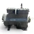 Front-right three-quarter view of a used Copeland 3DF3A-120E-TFD 12 HP compressor (3 phase 460 volt), dark gray semi-hermetic housing with a small red round inventory tag on the valve stem and a yellow warning tag hanging near the shaft-end flange.