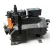Straight-on front view of the used Copeland 3DF3A-120E-TFD 12 HP compressor, showing the "Copeland Discus" nameplate, a foil-capped fitting at upper left, and a white paper service tag hanging from the shaft end on the right.