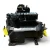 Front-right three-quarter view of a used Copeland 3DF4-R15ME-TFC 12 HP compressor (3 phase 208-230 volt), black semi-hermetic housing with the "Copelametic" nameplate, a red round inventory tag with orange paper attached, and a yellow oil-service checklist tag on the lower valve body.