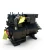 Front-on view of the used Copeland 9RS1-150A-TSC 15 HP compressor with valve stems and a copper tube fitting at top wrapped with a yellow oil-service tag, the terminal box at upper right, and a red round inventory tag numbered "124" hanging at left.