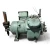 Elevated front-left three-quarter view of the used Carlyle 06EZ450-370 15 HP compressor (3 phase Dual Voltage), showing the sage-green cylinder head with hex bolts, a handwritten "3-3H-10" chalk marking on the housing, a silver terminal box with a weathered DANGER label, and a small blue oil filter canister mounted at the lower left.