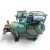 Closer front-right view of the used Carlyle 06EZ450370 15 HP compressor (3 phase Dual Voltage), with "COMPR #3" handwritten on the rust-mottled cylinder head, the same blue oil-safety switch canister, and heavier rust streaking down the housing consistent with a used, weathered unit.