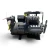 Front-right view of the used Copeland 6DL3-270E-TSK 27 HP compressor, 3 phase Dual Voltage, showing the hex-bolted cylinder head, a foil-capped service valve on the right, a red inventory tag, and a yellow tag on the left oil sight glass area.