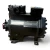 Front-left view of the used Copeland 2DD3-R63KE-TFC 5 HP Discus compressor (3 phase, 208-230 volt), showing the "Emerson Climate Technologies / Copeland" nameplate and a red round inventory tag partially visible at the left.