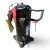 Close-up front view of the used Copeland ZF15K4E-TF5 5.5 HP compressor, 3 phase 208-230 volt, showing a green barcode inventory sticker, a red oval inspection tag, and the valve assembly with its printed part-number label.