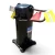 Front view of a used Copeland ZF18K4E-TF5 6 HP compressor, 3 phase 208-230 volt, showing a red round tag numbered "701" and a folded white paper tag with a yellow tag at the top, a copper stub pipe bent to the left, and the cast mounting base below.