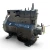 Three-quarter front-right view of the used Copeland 3DA3-R10ME-TFD 7.5 HP compressor, 3 phase 460 volt, showing a gray-black housing with a red inventory tag and yellow "add oil to compressor" tag hanging together near the base.