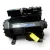 Three-quarter front-left view of the used Copeland 3DA3-R10ME-TFD 7.5 HP compressor, 3 phase 460 volt, with a gray-black housing, blue Copeland Discus nameplate, and a yellow "add oil to compressor" tag hanging near the base.