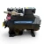 Straight-on front view of a used Copeland 3DA3-R10ME-TFD 7.5 HP compressor, 3 phase 460 volt, with a black housing, blue Copeland Discus nameplate, and a red round inventory tag hanging from a silver fitting on top.