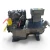 Front three-quarter view of the used Copeland 9RC1-101A-TFD 10 HP compressor (3 phase 460 volt), a black hermetic unit with the electrical terminal box in the upper right, cylinder head bolts visible upper left, and a yellow "ADD OIL TO COMPRESSOR" tag hanging from the valve.