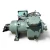 Front-right angled view of the used Carlyle 06EZ750-37ARP 15 HP compressor - 12050 (3 phase Dual Voltage), showing a different stamped code "3092" on the cylinder head, a black round oil-level sight glass/filter mounted at the left, and a rust-stained coupling flange with a foil-capped shaft at the right.