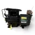 Angled front-right view of the used Copeland 6DL3-F93KE-TSK 27 HP compressor, 3 phase Dual Voltage, black finish, showing the finned oil cooler on top, a black "Copeland Danger" terminal box, and a yellow tag hanging from the base.
