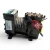 Front-right view of the used Copeland KAGA-010E-TAC 1 HP compressor - 11825, showing heavier dust/dirt buildup on the bolted valve plate, an orange "WHISPER CHARGED WITH NITROGEN" tag on the terminal box, and a blue-capped process tube at lower left.