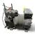 Front-left view of a used Copeland KARA-010E-TAC 1 HP compressor - 11831 (3 phase 208-230 volt), a gray/black semi-hermetic reciprocating compressor with two foil-wrapped process stubs and a red service valve fitting at the top left, and a yellow paper tag against the terminal box.