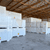 Stacked pallets of insulated cold storage panels wrapped in plastic