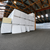 Stacked pallets of insulated cold storage panels wrapped in plastic, showing construction