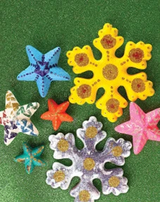 Glittery foam stars and snowflakes decorated with paint and sequins