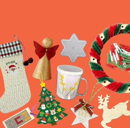 Handmade gifts including a cross-stitch stocking, a decorated mug, a pipe-cleaner wreath and wooden reindeer ornaments
