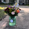 wild purple flower arrangement style in a nice goldish glass vase .