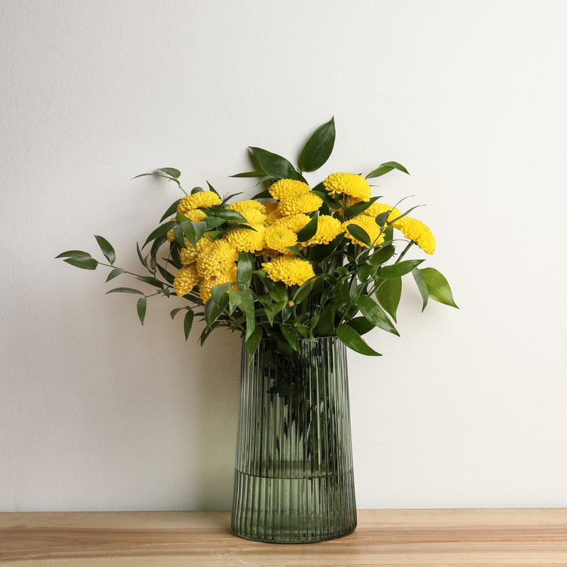 yellow chrysanthemums or mini mums in a nice vase for delivery in Houston tx