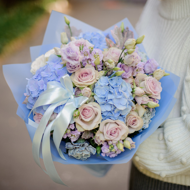 blue paper and flowers with lilac or lavender rose