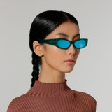 Side view of model wearing sunglasses | Cat-like sunglasses with green mirror lenses and green frames | Acetate | Ciara | Women's sunglasses | Karen Wazen Eyewear