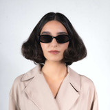 Front view of model wearing sunglasses | Oval sunglasses with black lenses and black frames | Metal & Acetate | Olivia | Women's sunglasses | Karen Wazen Eyewear