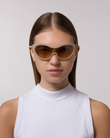 Front view of model wearing sunglasses | Mask-like sunglasses with cream lenses and cream frames | Acetate | Laser | Women's sunglasses | Karen Wazen Eyewear