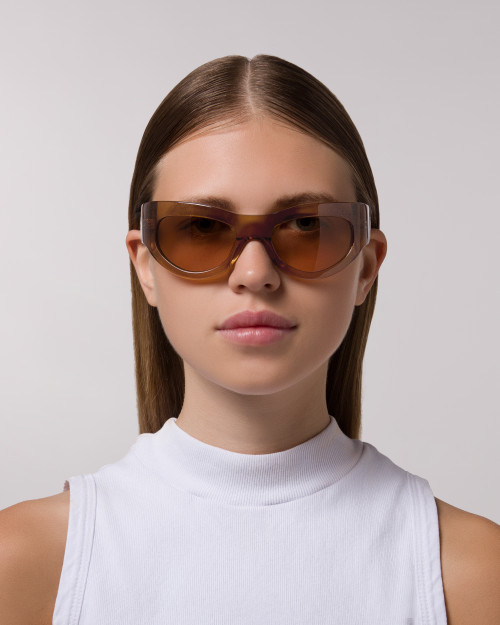 Front view of model wearing sunglasses | Mask sunglasses with light brown lenses and light brown frames |  Acetate | Swim | Women's sunglasses | Karen Wazen Eyewear