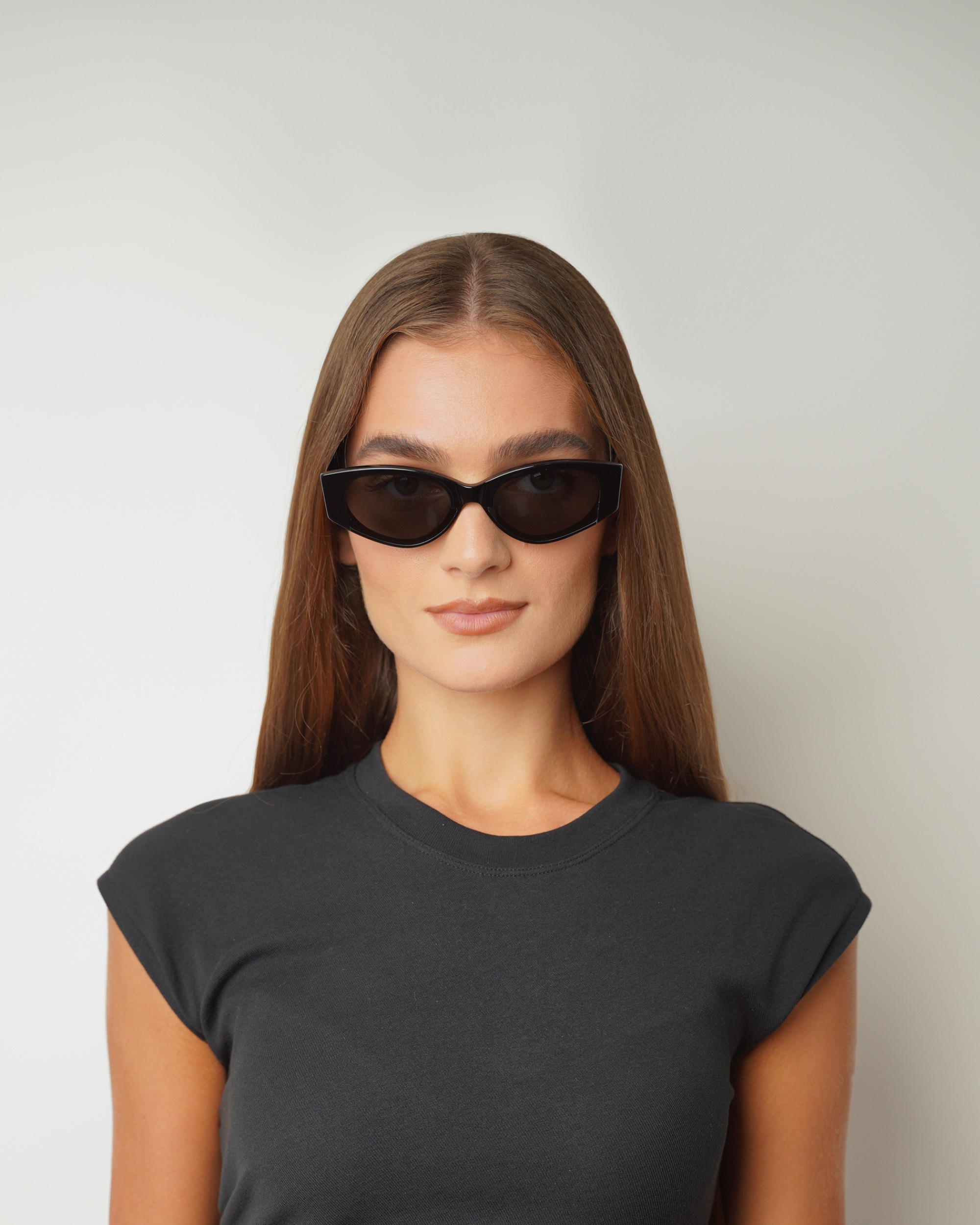 Front view of model wearing sunglasses | Cat-like sunglasses with black lenses and black frames | Acetate | Dixy | Women's sunglasses | Karen Wazen Eyewear