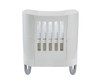 Mini crib in white with high mattress position