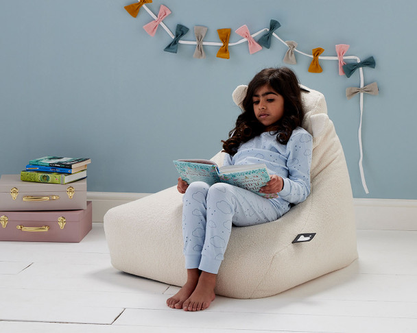 Girls sat on the teddy fleece beanbag in Ivory