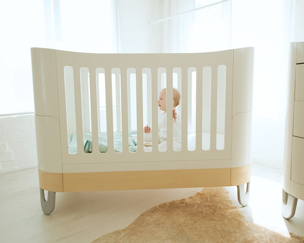 Baby in the cot bed in white & natural