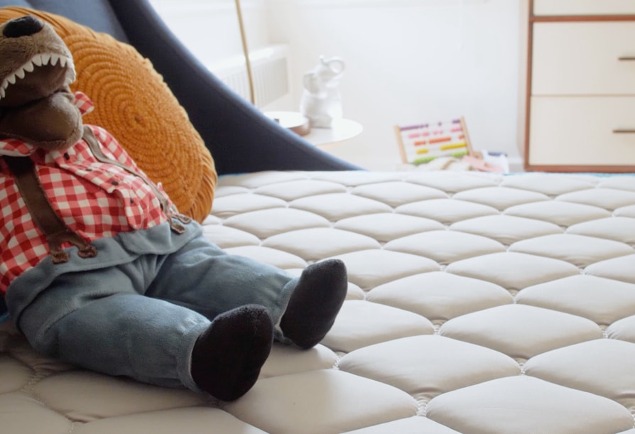 A stuffed animal and pillow on top of a Linenspa 6" Innerspring mattress 