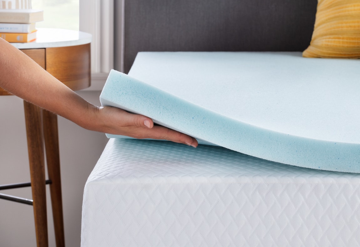 Hand holding up a 2 inch gel memory foam mattress topper