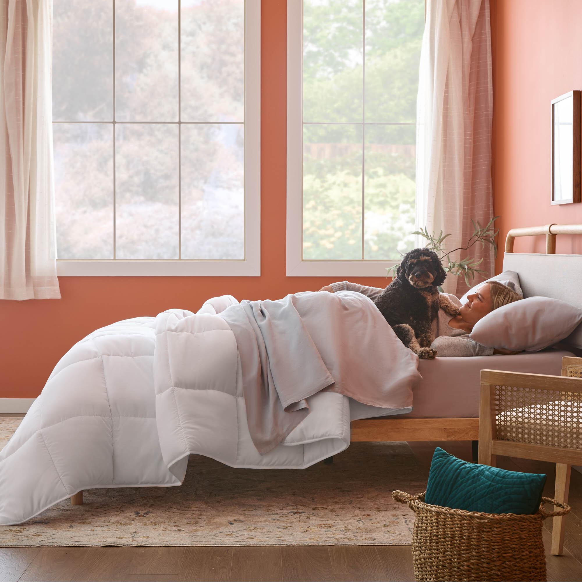 Woman and dog sleeping in bed.