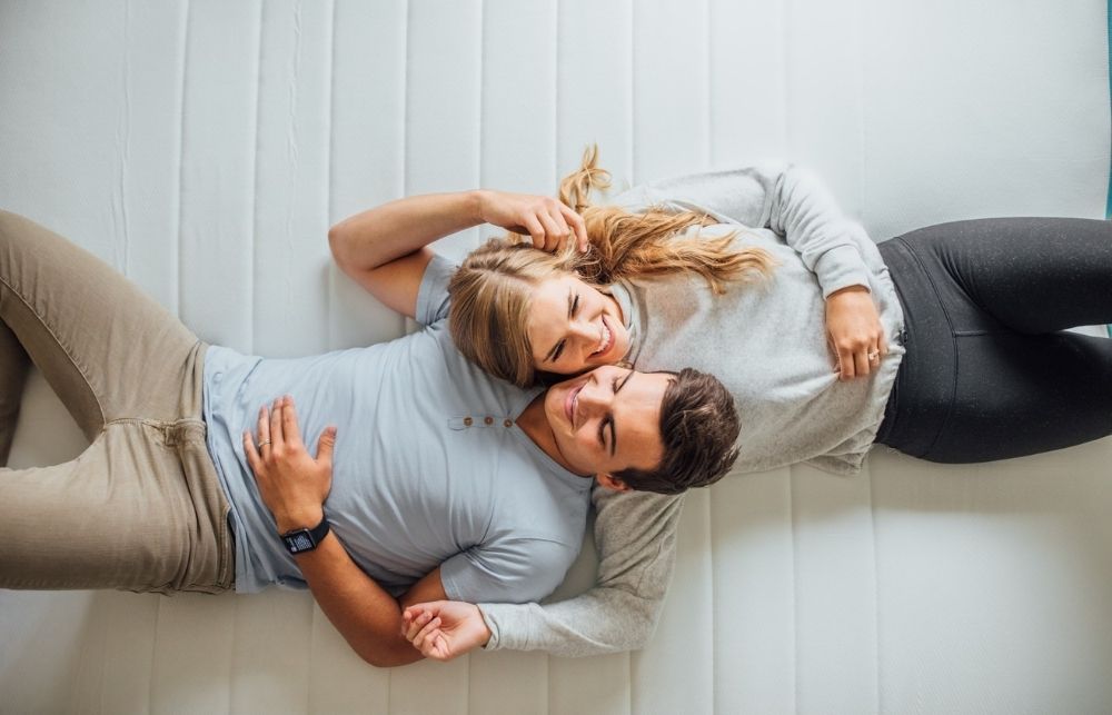 Overhead view of a couple laying down on a Linenspa 12" Memory Foam and Innerspring Hybrid Mattress