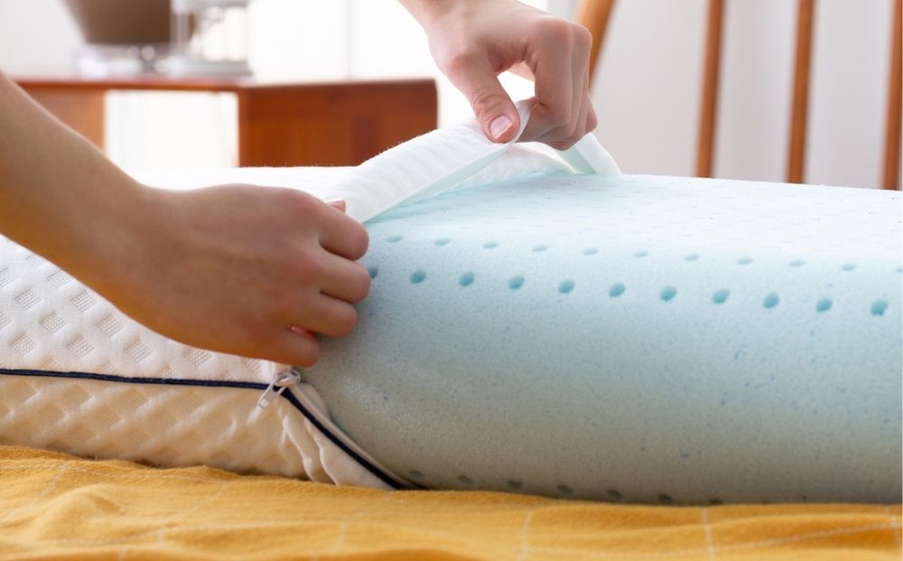 Person putting pillow in protective cover