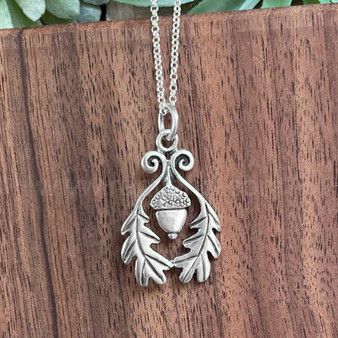 The Grizel Pendant features a capped acorn framed with oak leaves.