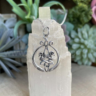 The Cygnet Pendant features 2 entwined baby swans facing outward above a curved trinity knot within a smooth frame.