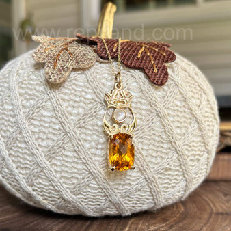 14kt yellow gold pendant with leaves and scrolls, with an 11.06ct Citrine and a 6mm Cat Eye Moonstone.
