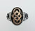 Large oval signet style ring with rose gold knotwork on the top.